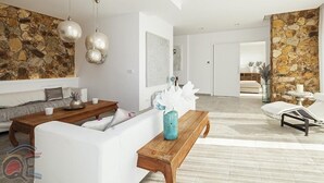 Una sala moderna con pared de piedra, muebles blancos y una mesa de centro de madera.