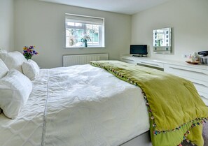 Good sized attractive bedroom with king size bed and fitted wardrobes