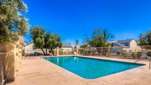 A rectangular swimming pool with a clear blue water, surrounded by a concrete deck. - Tucson Omni Oasis – 4BR-3BA Desert Retreat with Private Hot Tub & Fire Pit (Tucson)