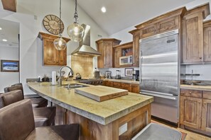 Enjoy cooking in this well-equipped kitchen with a large island, sink, and ample counter space.