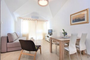 Apartment, 2 Bedrooms, Beach View (Royal) | Living area | Flat-screen TV