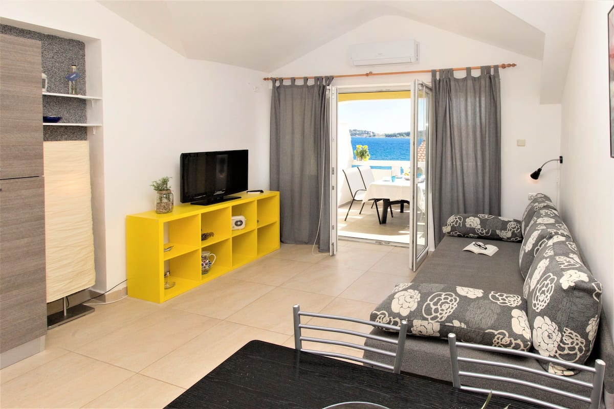 Apartment, 1 Bedroom, Beach View (Luxury) | Living area | Flat-screen TV