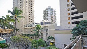 A high-rise building with multiple balconies, palm trees, and a clear sky. - Sea Shore 41 Private Studio in Waikiki, 1 Block to Beach (Honolulu)
