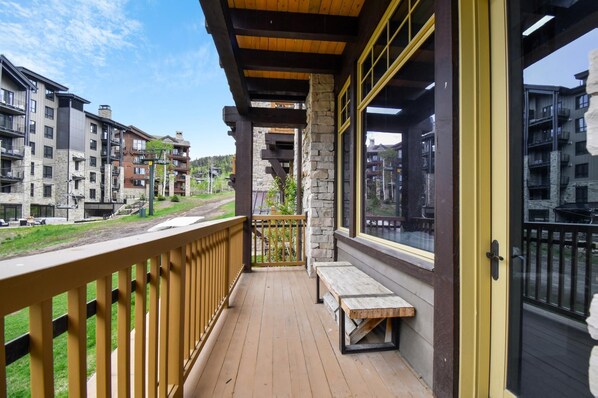 Enjoy the view from this balcony with a bench and access to multiple windows.