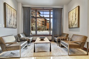 Relax in a stylish room with a city view, comfortable seating area, and artistic touches.