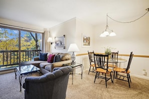 Relax in the well-appointed living room with a sofa, armchair, and dining area for a comfortable stay.