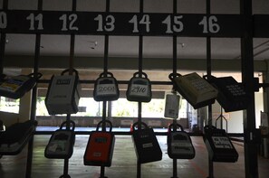 A row of numbered parking spaces with various types of parking meters attached.