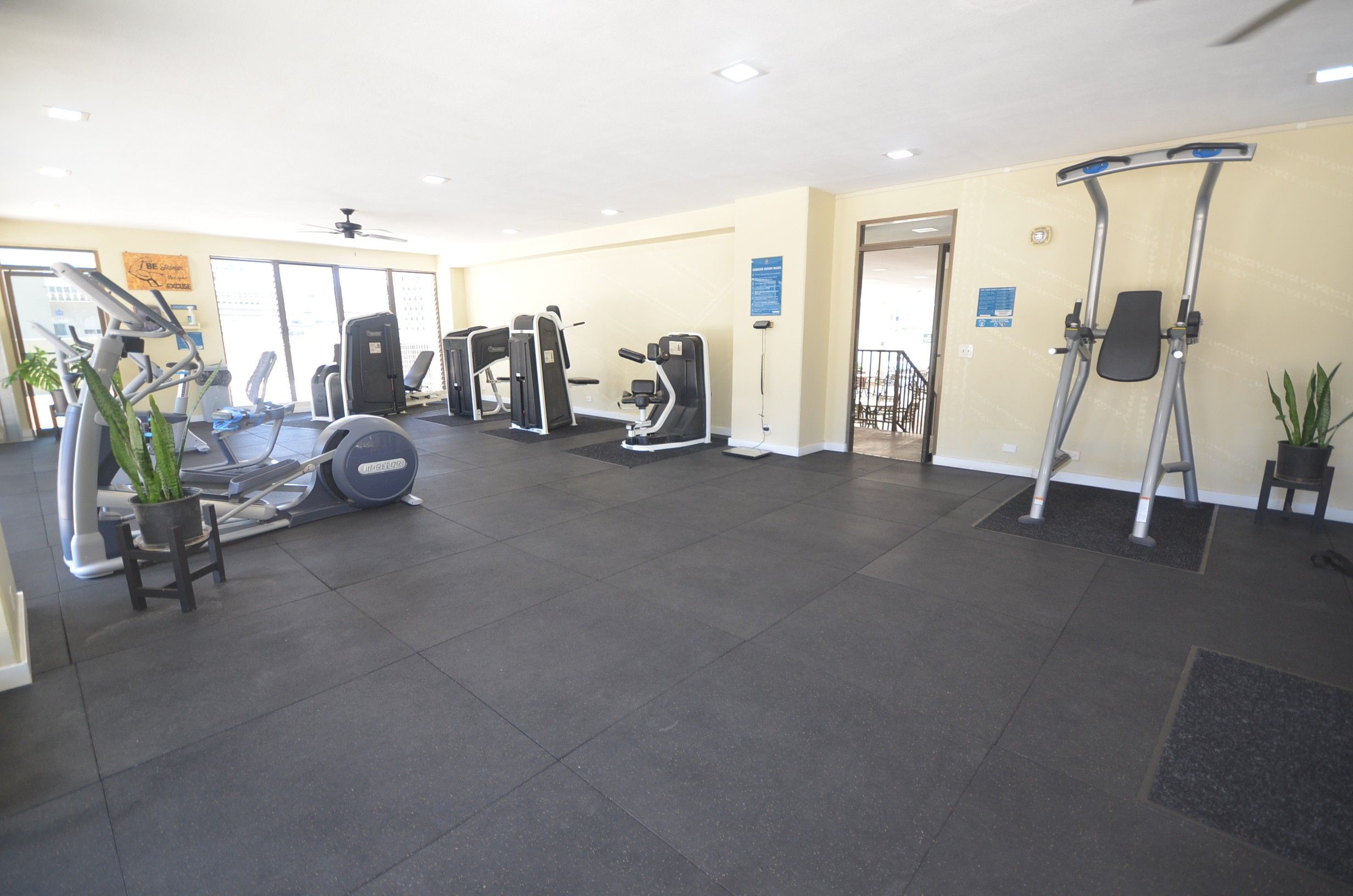 A gym with various exercise equipment, including treadmills and weight machines.