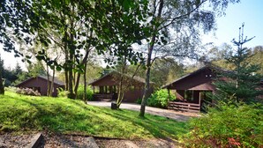 Ein Campingplatz mit Holzhütten, umgeben von üppigem Grün und Bäumen.
