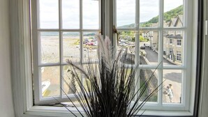 A window with a view of a beach and buildings.