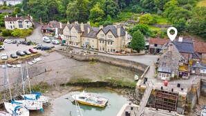 A coastal town with a marina, traditional buildings, and a stone bridge.