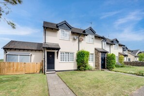 A two-story residential building with a front garden, a garage, and a stone extension. - 2 Bed in Instow (oc-n1093) (Instow)