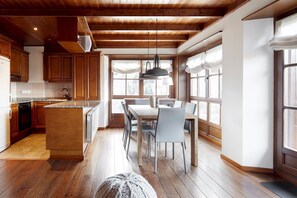 A modern kitchen with wooden cabinets, a granite countertop, and a central island.