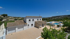 A building with a tiled roof, a swimming pool, and a paved courtyard. - Rustic and cheerful holiday home in Javea, Costa Blanca, Spain  with private pool for 6 persons (Javea)