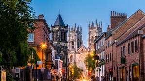 A street view with historic buildings, including a prominent cathedral with Gothic architecture. - 'The Snug' nr York: stunning self-contained studio @ Old Station Master's House. (Riccall)