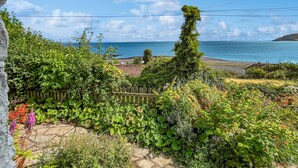 A garden with a variety of plants and a view of the sea. - The Crows Nest, Porlock Weir (Somerset)