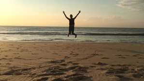 A beach with footprints leading to the water, a person jumping in the air, and the ocean in the background. - OCEANBAHIA12 rental luxury 6 pers Club 5 * clim Montalivet Aquitaine  (Vendays-Montalivet)