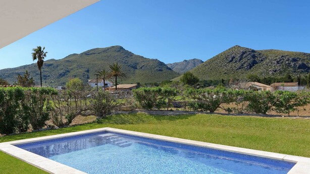 Piscina com vista para montanhas e céu claro.