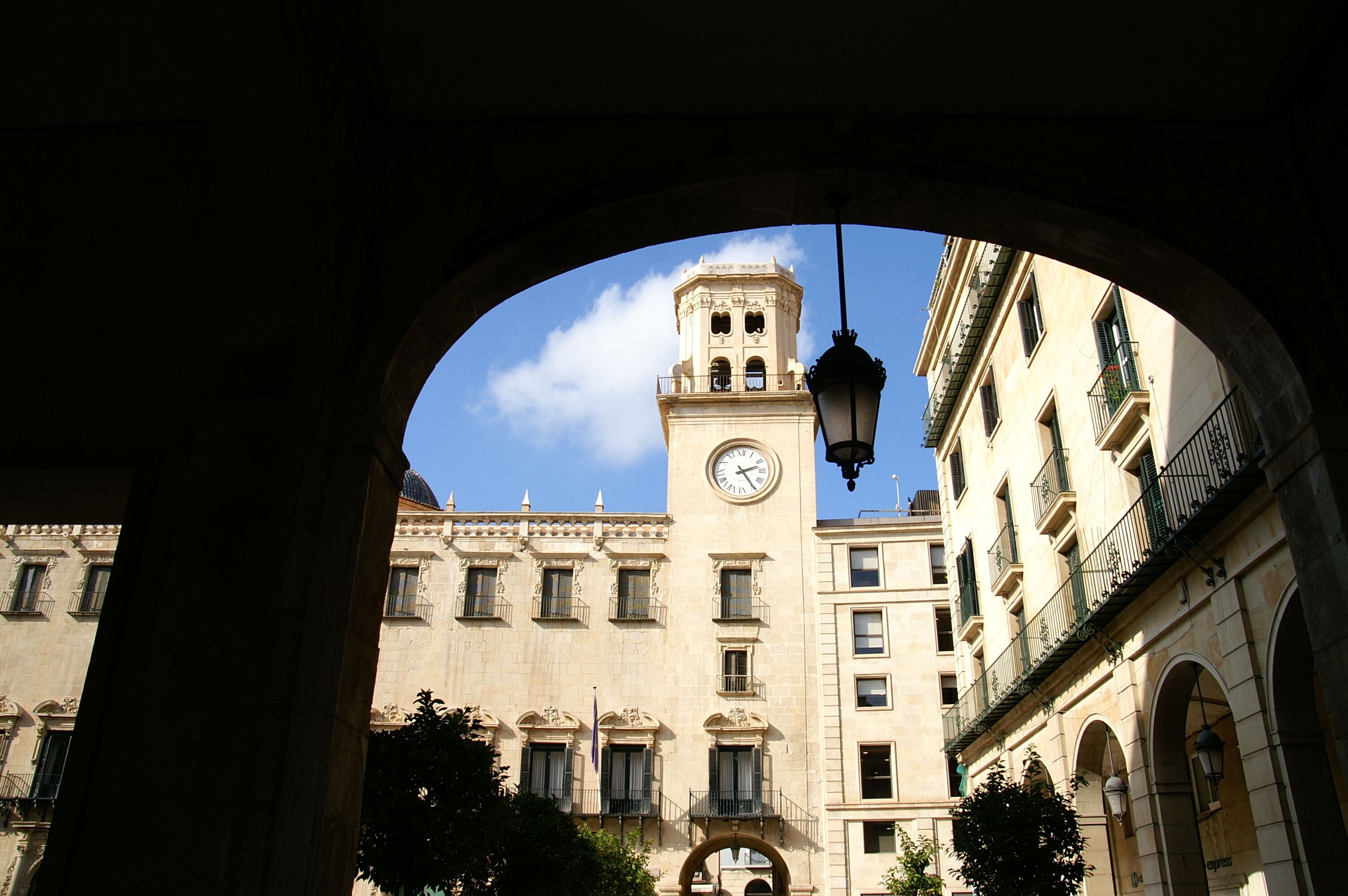 A historic building with a clock tower, arched windows, and a stone facade.