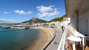 A coastal view with a beach, marina, and buildings.