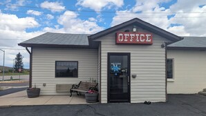 A small building with a sign reading "OFFICE" and a welcome sign on the door. - Western Inn (Green River)