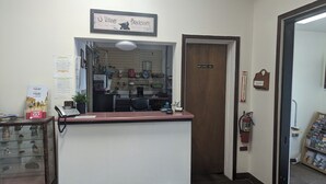 A reception area with a counter, a fire extinguisher, and a door labeled "Employees Only". - Western Inn (Green River)