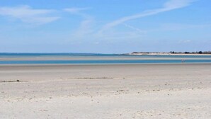 A beach with a wide sandy area and a calm sea. - Garden Flat -  comfortable cottage for two close to Chichester and Goodwood (Tangmere)
