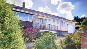 A two-story house with a stone facade, a large window, and a garage. - 4 Bed in Appledore (oc-tidal) (Appledore)