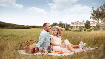 Couples can enjoy a romantic picnic in the lush green surroundings.