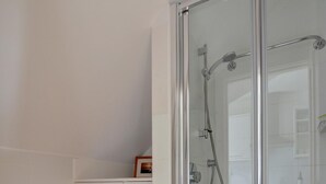 A modern bathroom with a glass-enclosed shower, a white sink, and a cabinet with drawers. - 1 Bed in Woolacombe (oc-seablu) (Woolacombe)