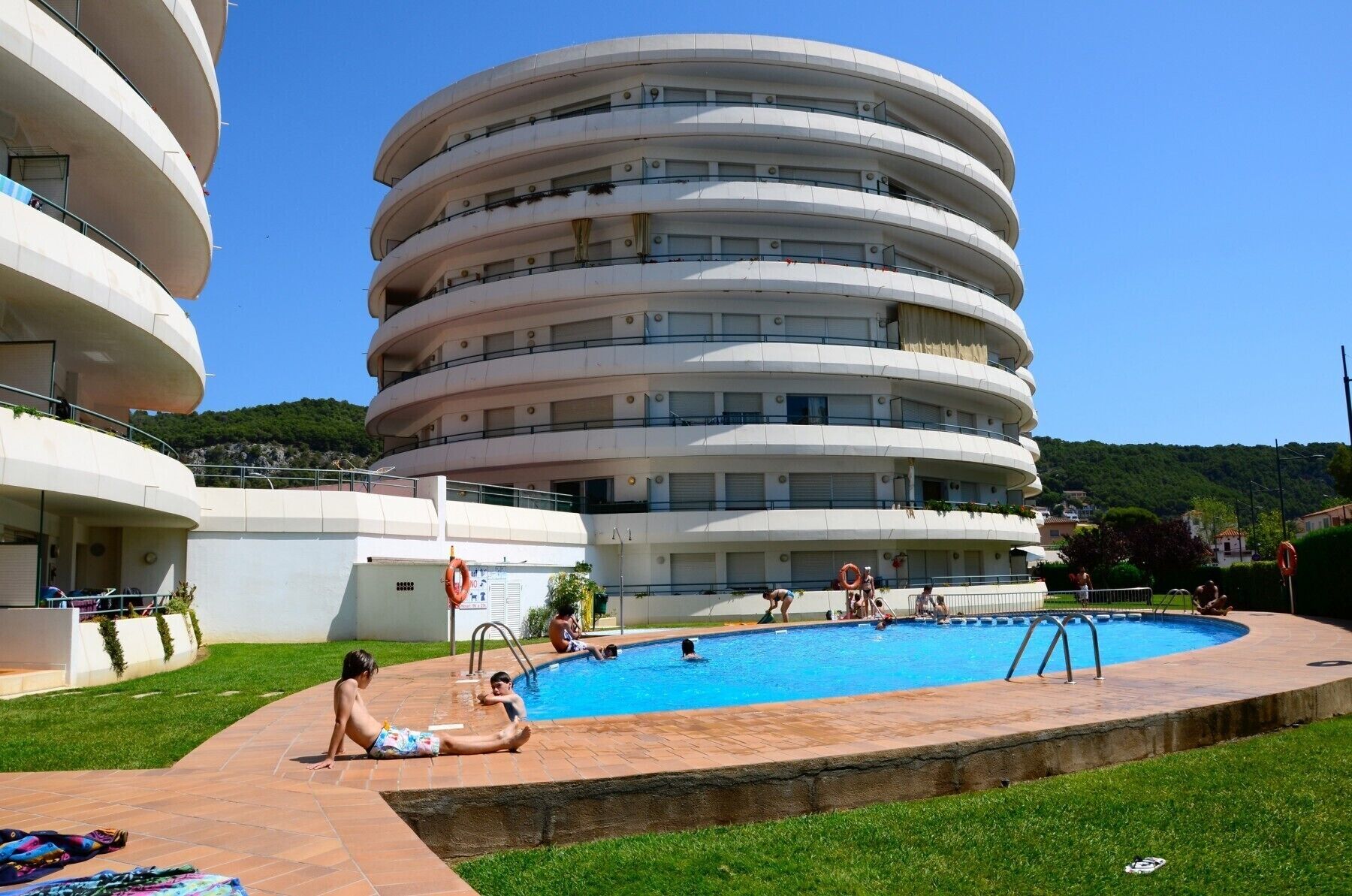 A multi-story building with a pool area.