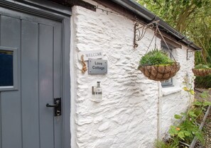 Experience the charm of a country-style home with a quaint exterior and a welcoming entrance.