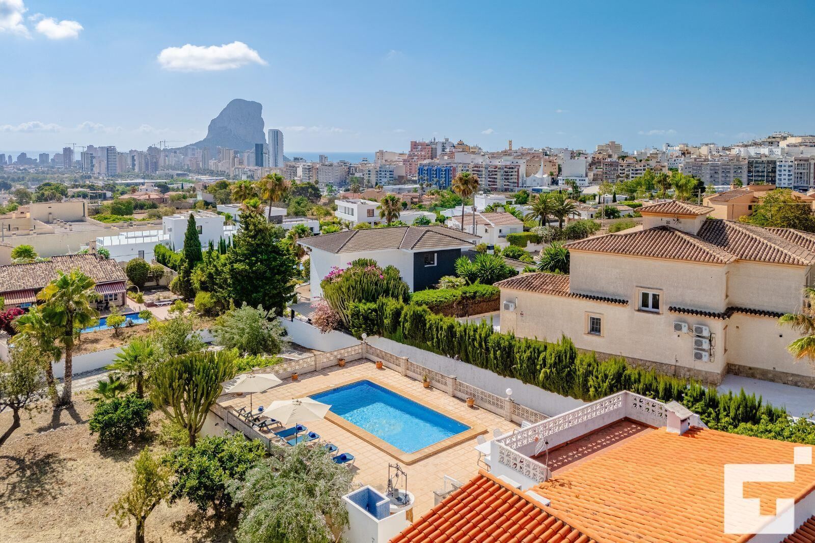 Zona residencial con piscina, rodeada de vegetación y vistas del horizonte de la ciudad.