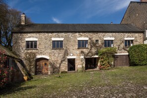 A stone building with multiple windows and a central door, surrounded by a cobblestone courtyard. - The Ballroom, near Wheddon Cross (Wheddon Cross)