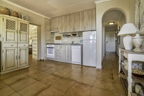 A kitchen with white cabinets, a refrigerator, and a stove. - Apartment Brisa - PlusHolidays (Calpe)