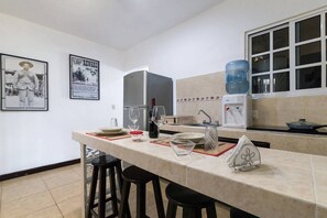 Enjoy cooking in this well-equipped kitchen with a sink, refrigerator, and coffee maker.