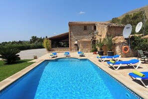 A swimming pool with lounge chairs, a stone building with a tiled roof, and satellite dishes. - Magnificent Memory Making - only 2km beach! (Palma de Mallorca)