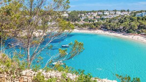 A coastal view with clear turquoise waters, a rocky shoreline, and buildings in the background. - Villa Mascaro - Six Bedroom Villa, Sleeps 12 (Serpentona)
