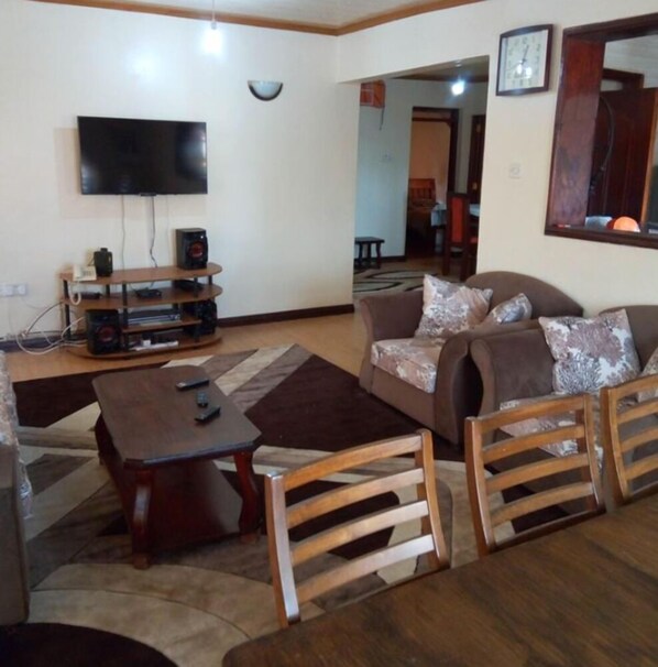 Comfort Apartment | Living area | Flat-screen TV, fireplace, DVD player - Honass Riara Apartment (Nairobi)