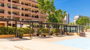 A covered outdoor area with planters and a bus stop shelter. - Apolo XVI 67 - Grupo Turis - Calpe, Costa Blanca (Calpe)