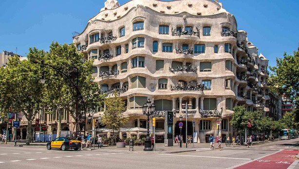 A building with a unique architectural style, featuring balconies and a curved facade.