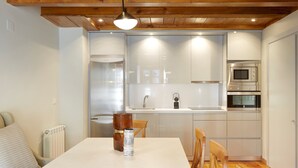 A compact kitchen with white cabinets, a built-in microwave, and a sink. - Besiberri by FeelFree Rentals (Garós)