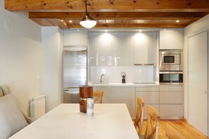 A compact kitchen with white cabinets, a built-in microwave, and a sink.
