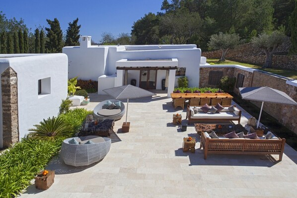 A rooftop patio with a dining area, seating, and a pergola. - VILLA CAN RIBES - IBIZA LUXURY by Priority (Santa Eulalia del Río)