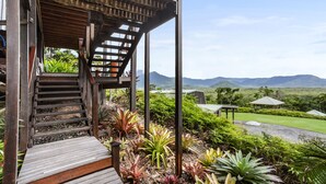 A wooden staircase leading to a covered area with a view of mountains. - Daintree Holiday Homes - La Vista - Private Pool & Jet Spa - Ocean Views (Cow Bay)