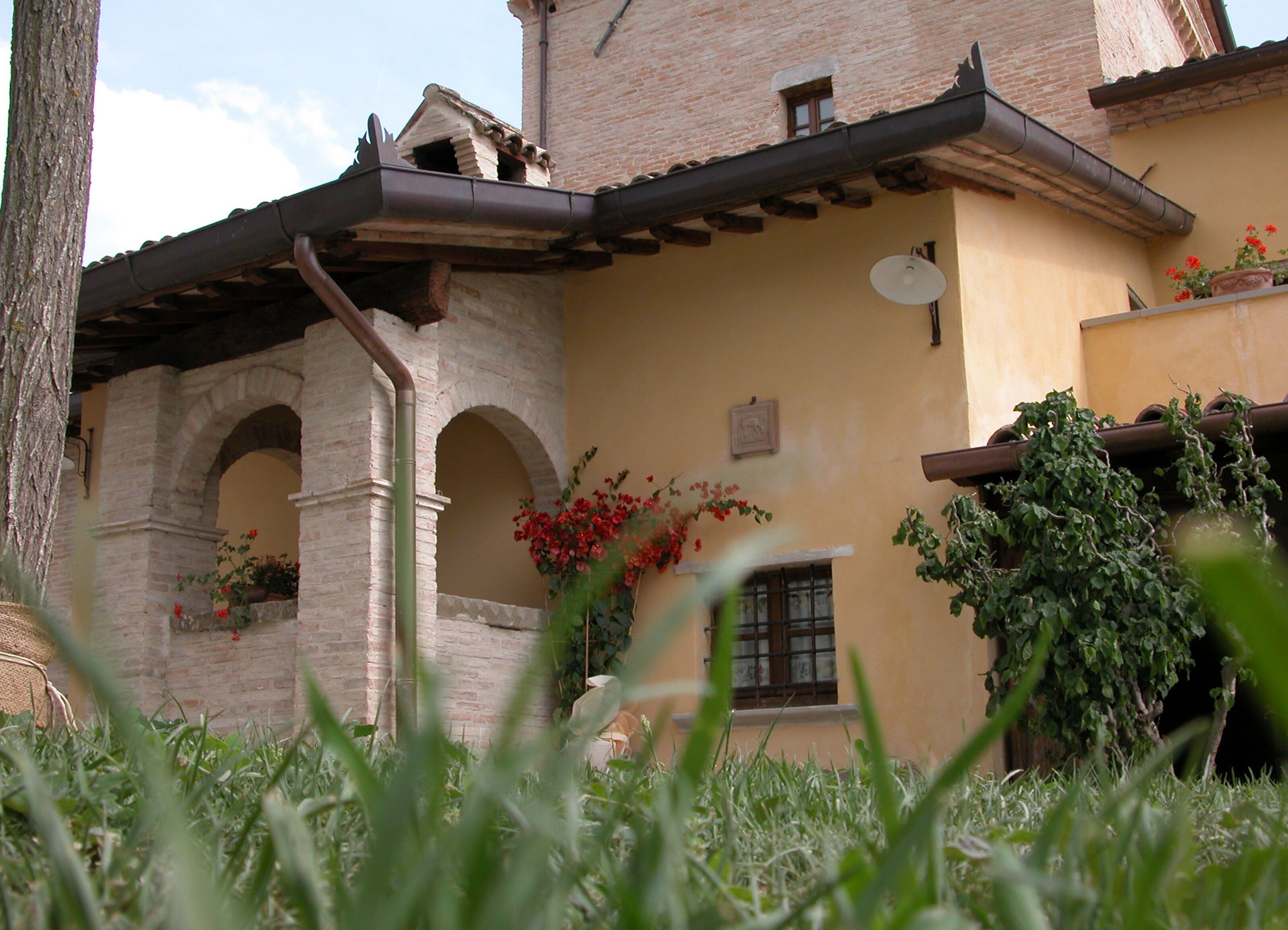 A traditional building with a brick facade, arched windows, and a tiled roof.