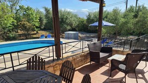 An outdoor patio with a pool, wicker furniture, and a view of the pool area. - Villa near Almyrida ☀️ Private Pool Gated For Child Safety ☀️ FREE WiFi (Old Road, Gavalochori - Almyrida)