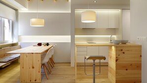 A modern kitchen with wooden countertops, a built-in sink, and pendant lighting. - Santa María by FeelFree Rentals (San Sebastián)