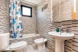 Combined shower/tub, hair dryer, towels, soap
