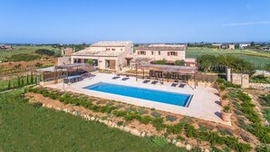 A large house with a swimming pool and outdoor seating area. - VILLA ES TRENC - SA SINIA VELLA (Campos)